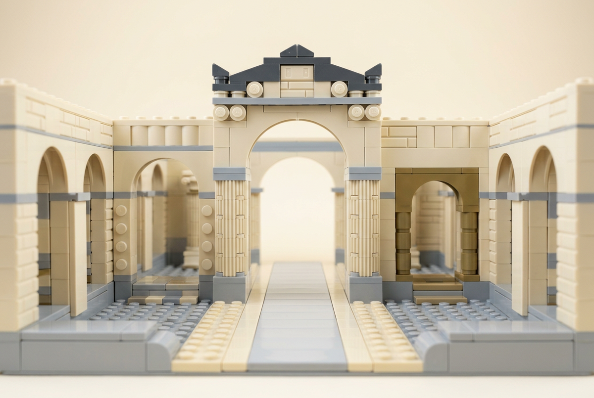 Brick-built ancient Roman courtyard with columns, an arch and open pathways